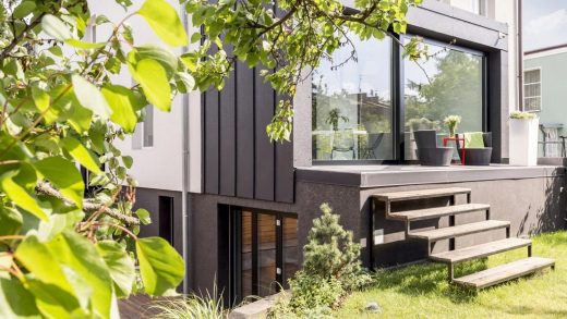 Modern private villa in the UAE with large glass windows and garden, protected by a custom security plan